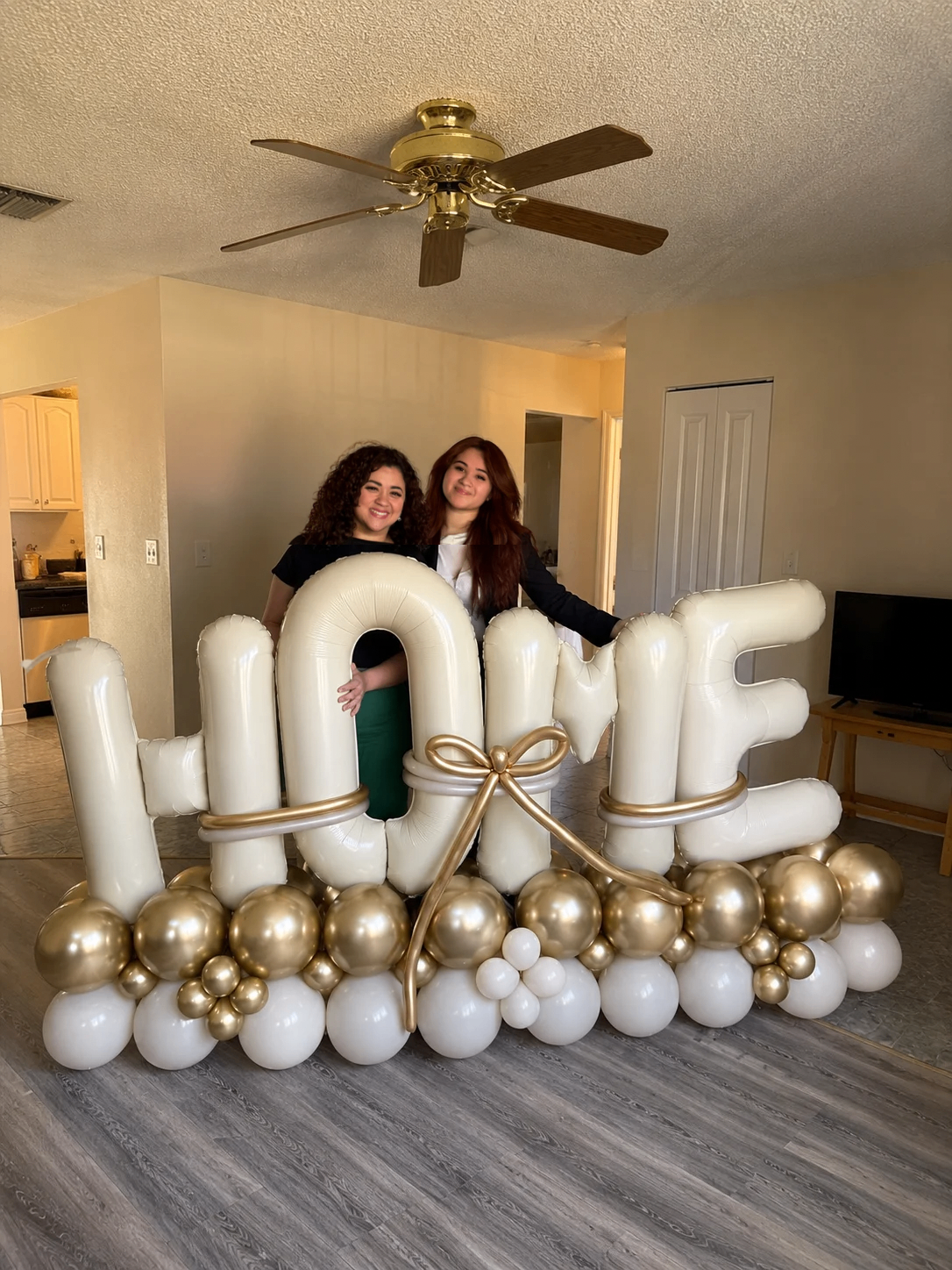 Irma Padilla celebrating client's new home with HOME balloon arrangement